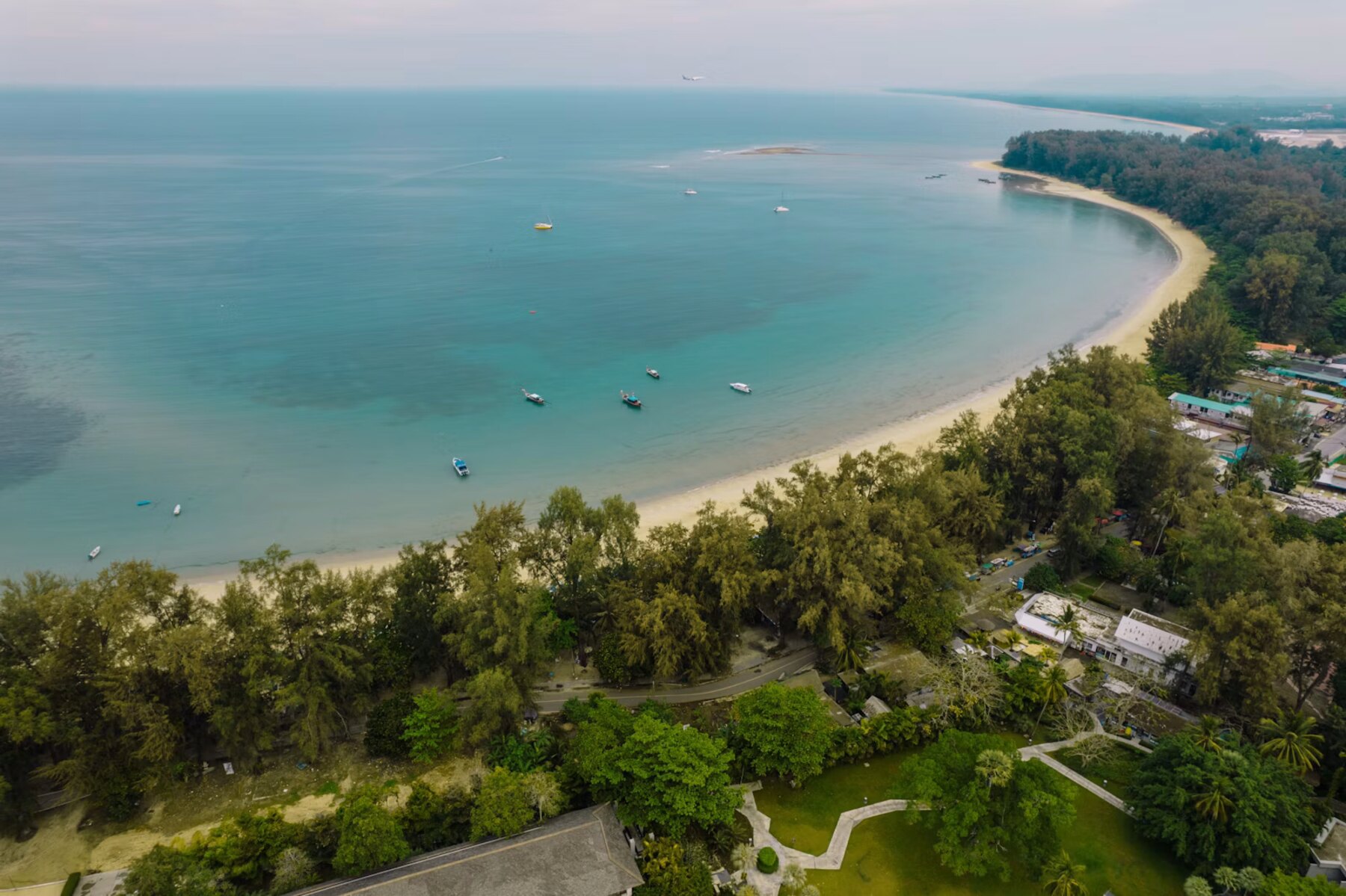 Surin Beach, Phuket, seen from the air, the bay curving north toward Bang Tao