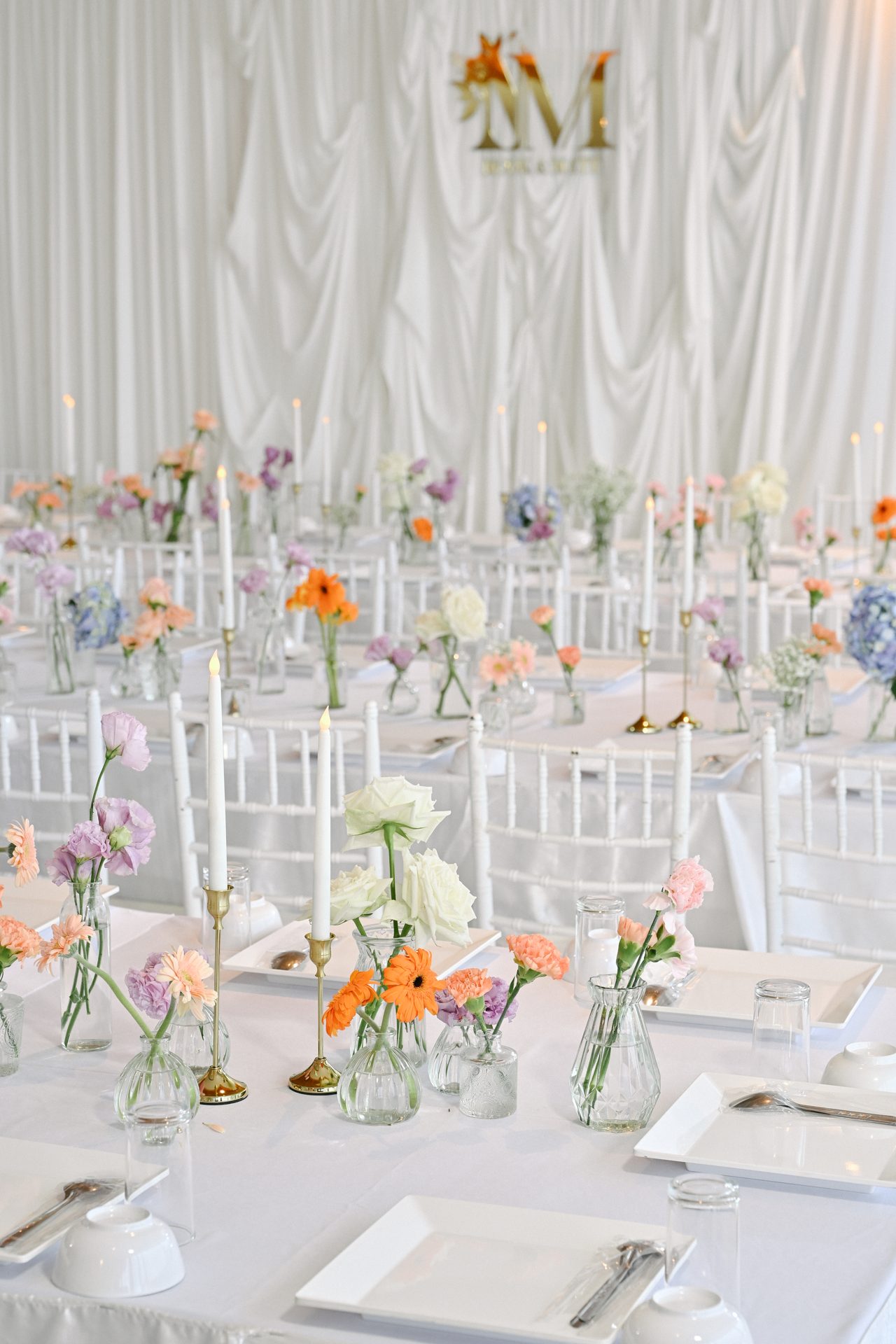 All-white wedding table setting with candles and flowers at Samsara villas, Phuket